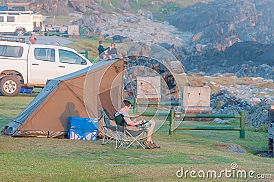 Tourist reading a book at tent Editorial Stock Photo