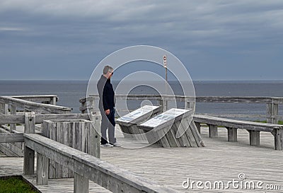 Tourist reading the information plaque on the boardwalk at Dungeon Provincial Park Editorial Stock Photo