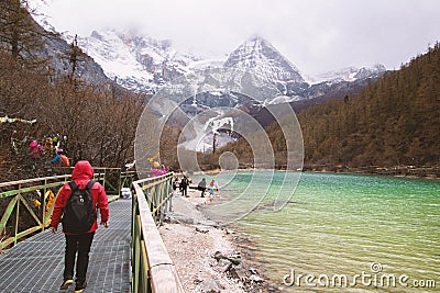 Tourist relax meditation with serene view mountains and lake landscape in the morning. Travel lifestyle hiking summer vacations Editorial Stock Photo