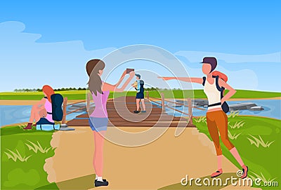 Tourist relaxation photographing wooden bridge across river mountain landscape background expedition concept flat Vector Illustration