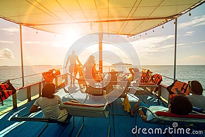 Tourist relaxing on cruising ship roof and sun light skies ahead Editorial Stock Photo