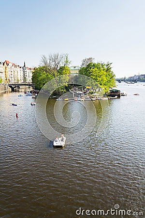 Tourist sailing on pedal boats on Vltava river near Charles bridge in Prague, Czech Republic Editorial Stock Photo