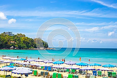 Tourist seaside resort in Asia. Vacationers tourists, rows of sun loungers and umbrellas on the sea beach. Rest and Editorial Stock Photo