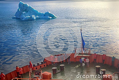 Tourist ship sails close to small iceberg Editorial Stock Photo