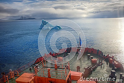 Tourist ship sails close to small iceberg Editorial Stock Photo