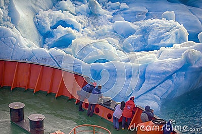 Tourist ship sails close to small iceberg Editorial Stock Photo