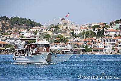 A tourist ship with stone windmill in Ayvalik, Turkey Editorial Stock Photo