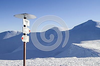 Tourist sign inscription - Gendarme, Dragobrat, Bliznitsa - on the snow-covered Svydovets mountains Stock Photo