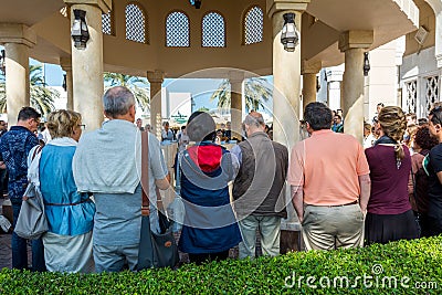 Tourist standing at the ablution taps of Wudu pavilion Jumeirah Mosque, the only mosque in Dubai which is open to the public and Editorial Stock Photo