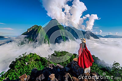 Tourist standing on Pha Dang viewpoint at sunrise in Muang Ngoy, Laos Stock Photo