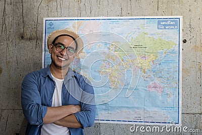 Tourist standing with worldmap on wall, plans for next destination, lifestyle concept. Stock Photo