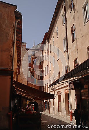 A tourist street in Lwow, Ukraine. It is narrow and old. The light source is sun Editorial Stock Photo