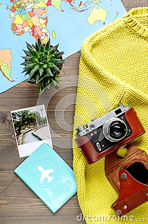 Tourist stuff with camera and map on wooden background top view Stock Photo