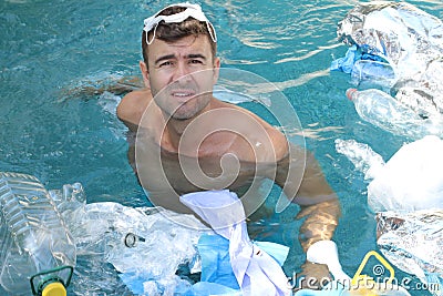 Tourist swimming in polluted waters Stock Photo