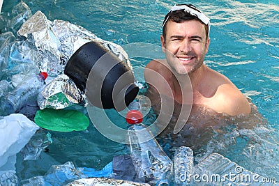 Tourist swimming in polluted waters Stock Photo