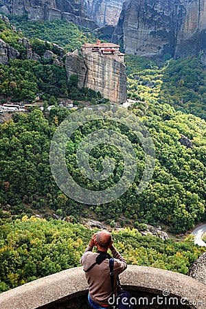 A tourist takes a photo of the amazing panorama of Meteora Stock Photo