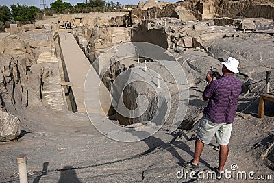 A tourist takes a photograph of the Unfinished Obelisk at the ancient Western Quarry near Aswan in Egypt. Editorial Stock Photo