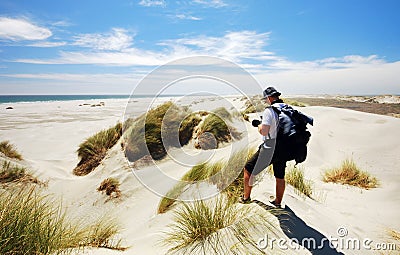 Tourist taking photo of Farewell spit sand dunes Stock Photo