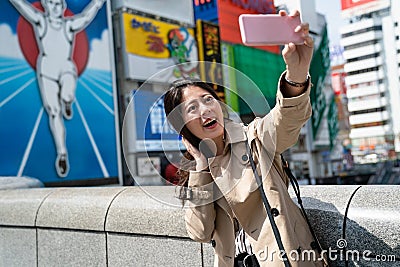 Tourist taking selfie,glico running man Editorial Stock Photo