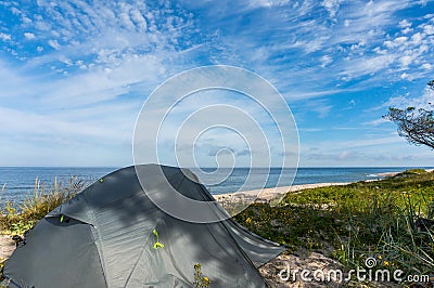 Tourist tents on the Baltic sea coast, camping on the sea coastline Stock Photo