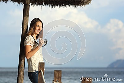 Tourist traveler girl enjoying holidays looking a seascape on the beach Stock Photo