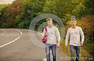 Tourist traveler travel auto stop. Transporting issues. Pick spot where car can easily pull aside. Men backpack walking Stock Photo