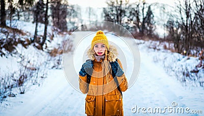 Tourist traveler woman is in the winter woods on a snowy road Stock Photo