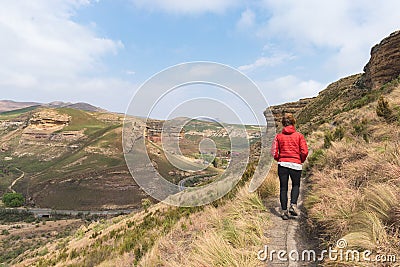 Tourist trekking on marked trail in the Golden Gate Highlands National Park, South Africa. Scenic table mountains, canyons and cli Stock Photo