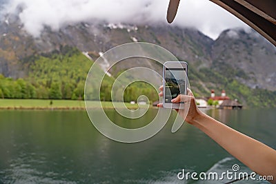 Tourist try to take photo shooting point by their smartphone in Lake Hallstatter Stock Photo