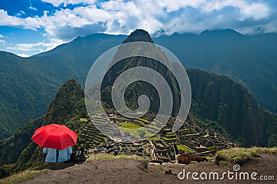 Tourist under red umbrella at Machu Picchu Stock Photo