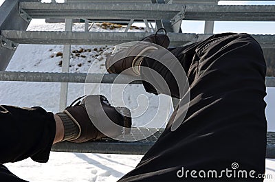 The tourist view from with metal stairs glides dangerously in the winter. hiker in hiking boots fell from the skin and lying injur Stock Photo