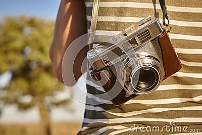 Tourist with vintage camera in the countryside. Travel background. Stock Photo