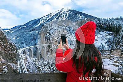 Tourist visiting Landwasser Viaduct world heritage in Swiss Alps snow winter scenery, Switzerland Stock Photo