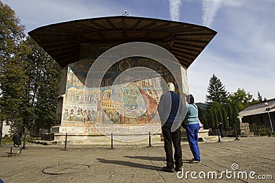 Tourist at Voronet monastery, Romania Editorial Stock Photo