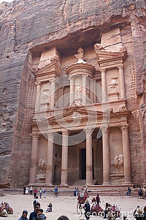 Tourist walking around beautiful Roman architecture of the treasure one of the most iconic monuments in the Petra Archaeological Editorial Stock Photo