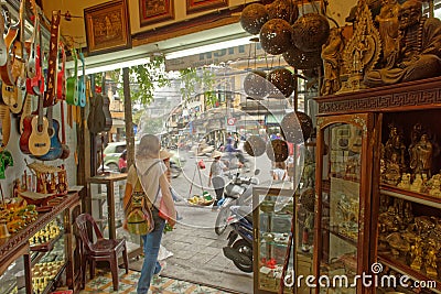 Tourist walking out of handcrafts shop Editorial Stock Photo