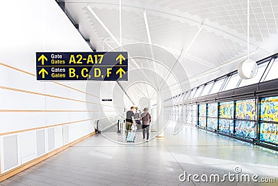 Tourist are walking to different gate by follow the gate label w Editorial Stock Photo