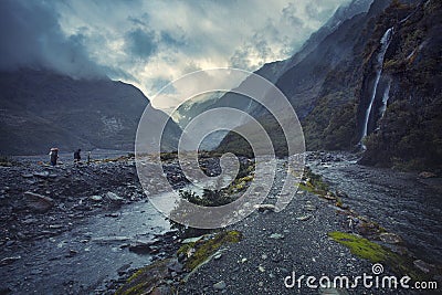 Tourist walking on trail to franz josef glacier in foggy weather Editorial Stock Photo