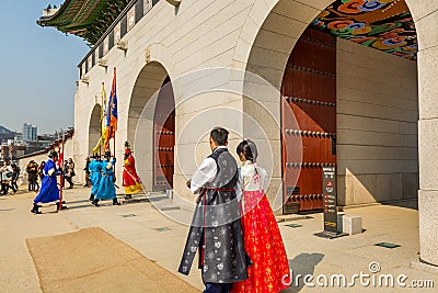 Tourist watching the warriors of the Royal guard in historical costumes in daily Ceremony of Gate Guard Change near the Editorial Stock Photo