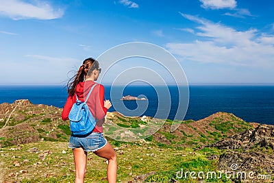Tourist woman with backpack on Cap de Creus, natural park. Eastern point of Spain, Girona province, Catalonia. Famous tourist Stock Photo