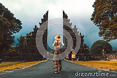Tourist at vacation walking through the Hindu temple in Bali Stock Photo