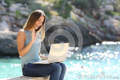 Tourist woman on holidays enjoying online with a laptop Stock Photo