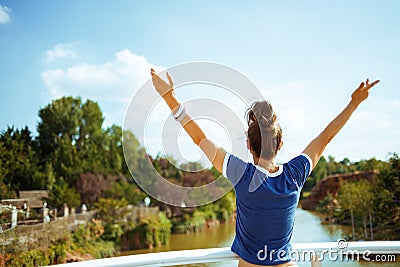 Tourist woman on river boat rejoicing while having river voyage Stock Photo