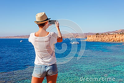 Tourist woman on sunny resort beach at the coast of Red Sea in Sharm el Sheikh, Sinai, Egypt, Asia in summer hot. Ð¡oral reef and Stock Photo