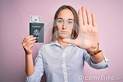 Tourist woman on vacation holding usa passport with dollars banknotes as a travel money with open hand doing stop sign with Stock Photo