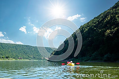 Tourist on yellow packraft rubber boat with red padle Stock Photo