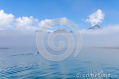 a tourist Zodiac enters the foggy bay of the now abandoned whaling station at Grytviken - on South Georgia. Stock Photo