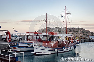 Touristic boat against Spinalonga island Stock Photo
