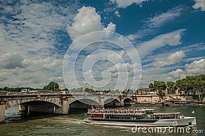 Touristic boat and bridge over the Seine River under a sunny blue sky in Paris. Stock Photo