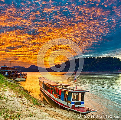 Touristic boat at sunset. Beautiful landscape. Luang Prabang. La Stock Photo